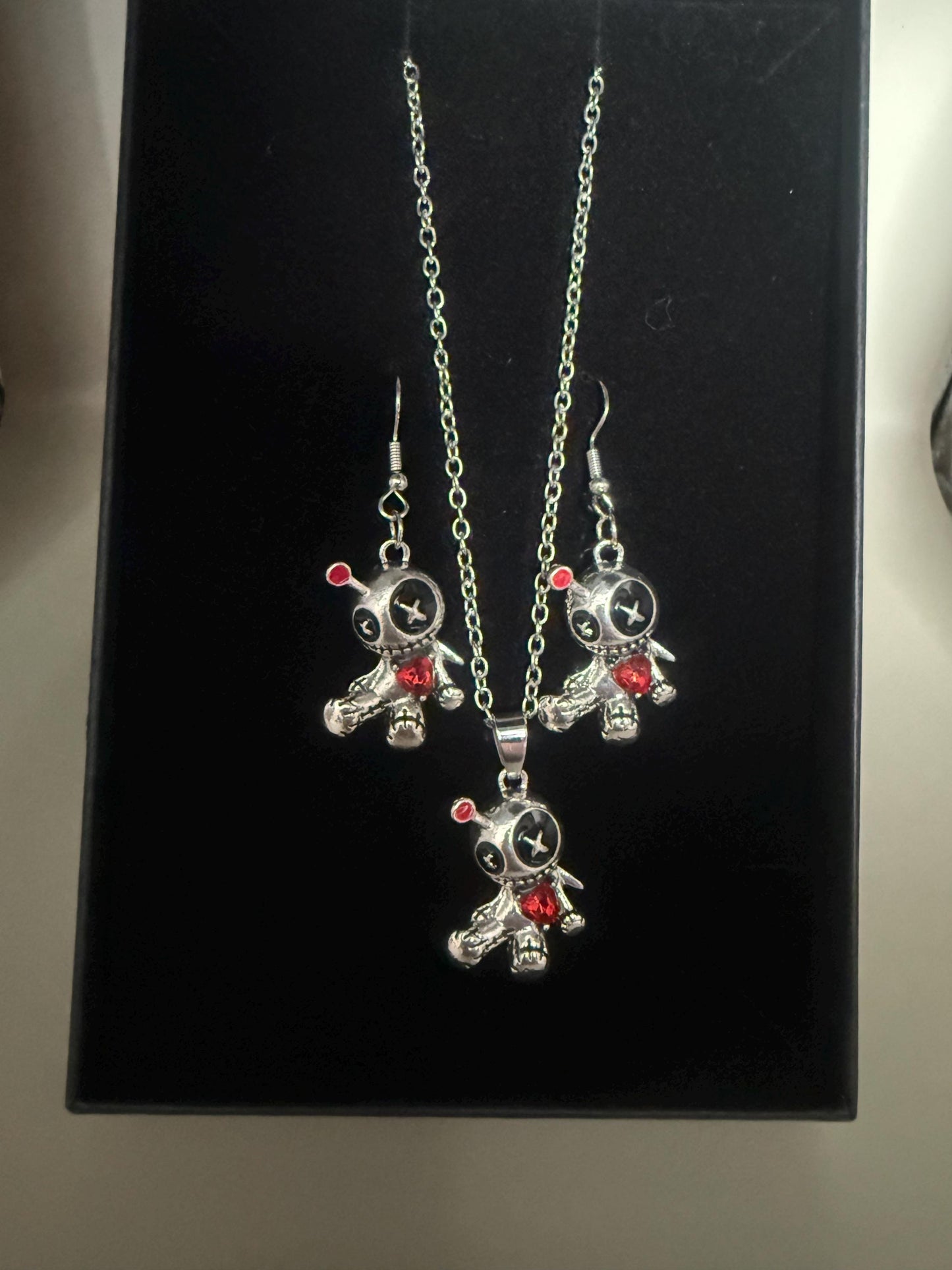 Cute voodoo doll jewellery set, earrings and pendant necklace.