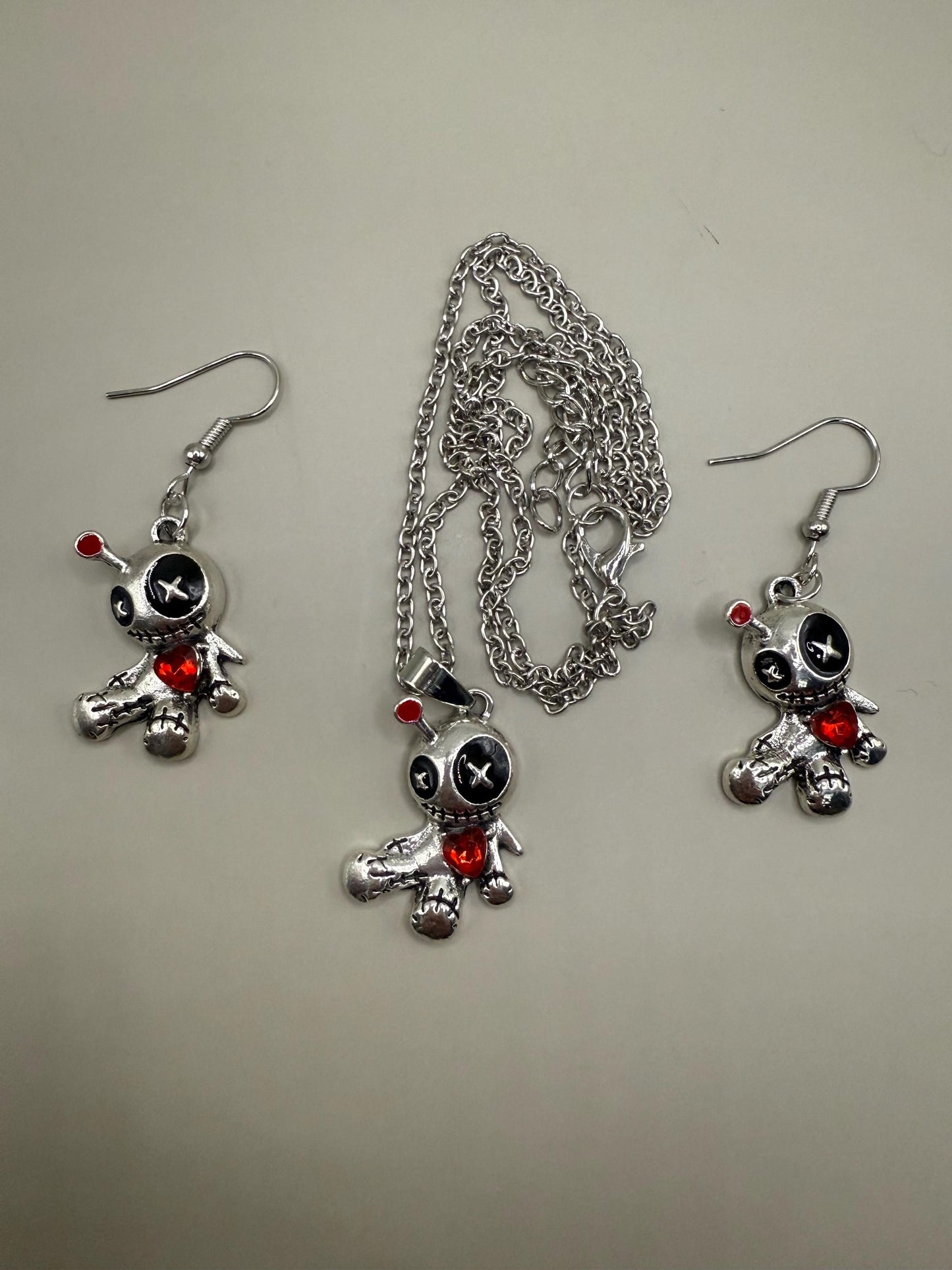 Cute voodoo doll jewellery set, earrings and pendant necklace.